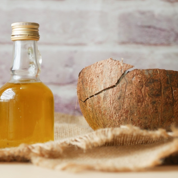 little bottle with liquid and a coconut shell