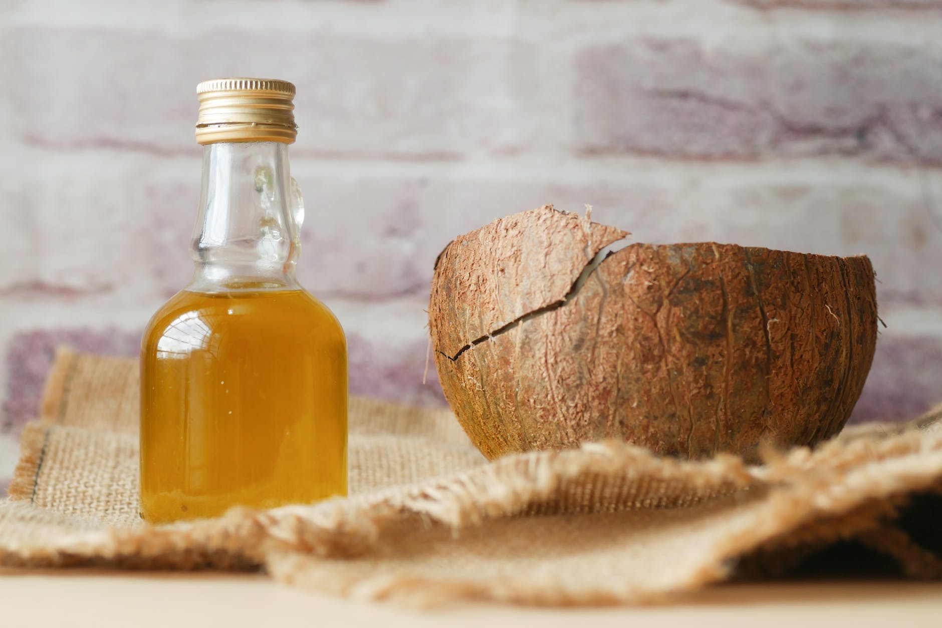 little bottle with liquid and a coconut shell