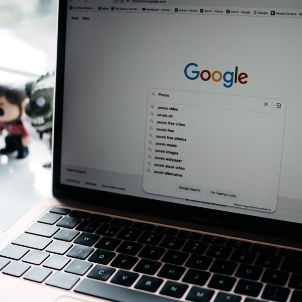 photo of a laptop screen with google main page on it