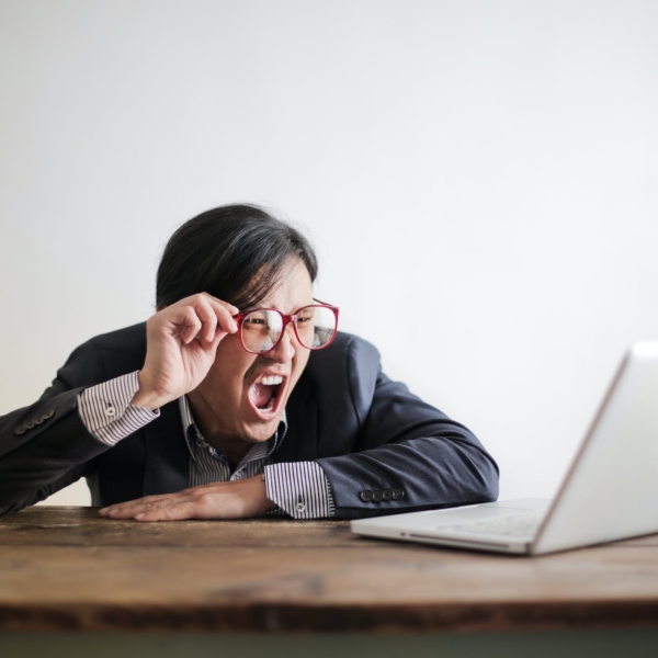 yelling formal man watching news on laptop
