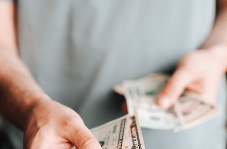 crop man paying with american dollars