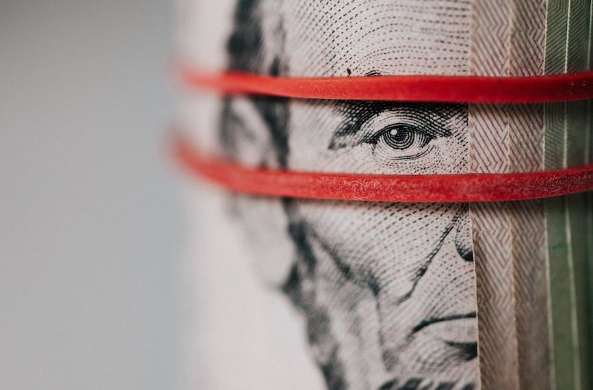 roll of american dollar banknotes tightened with band