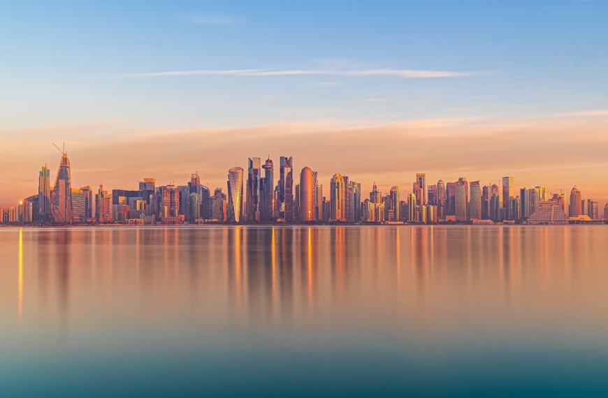 scenic cityscape of modern coastal megapolis under sunset sky