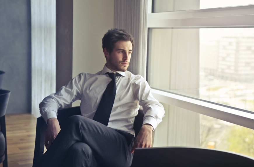 man wearing white dress shirt and black necktie
