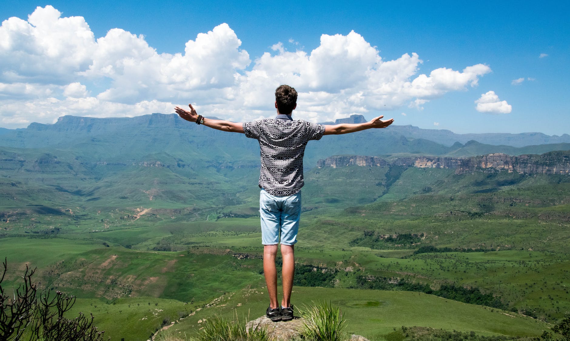 man wearing grey shirt standing on elevated surface