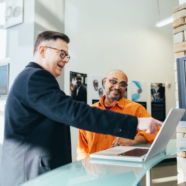 man pointing laptop computer