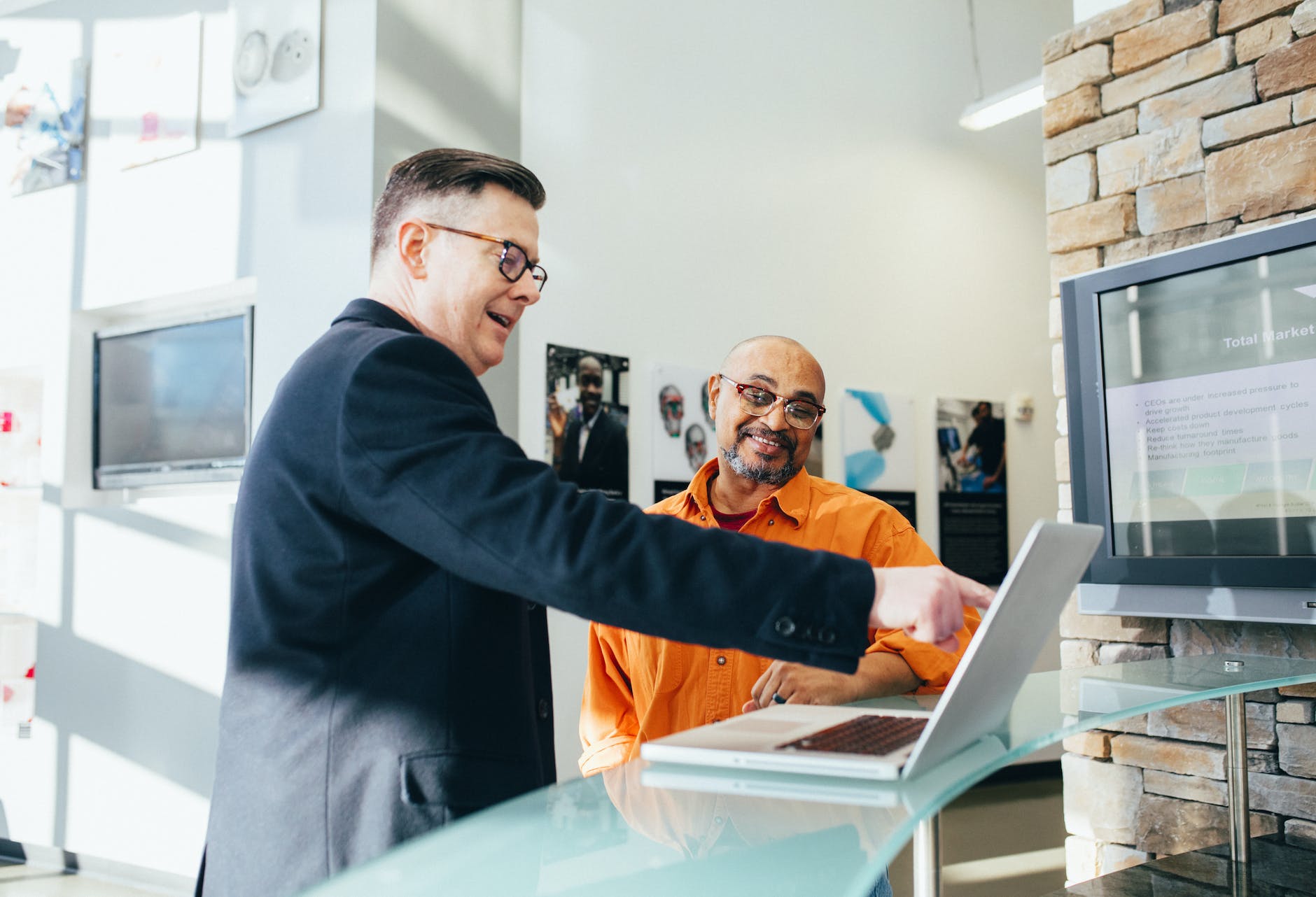 man pointing laptop computer