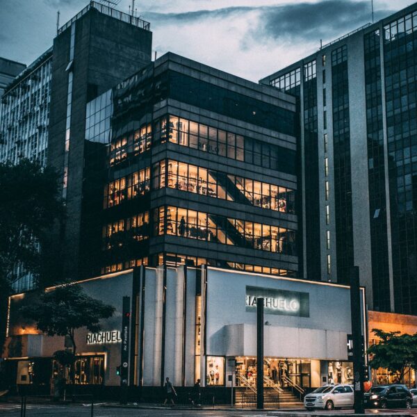 black high rise building under grey and white sky during night time