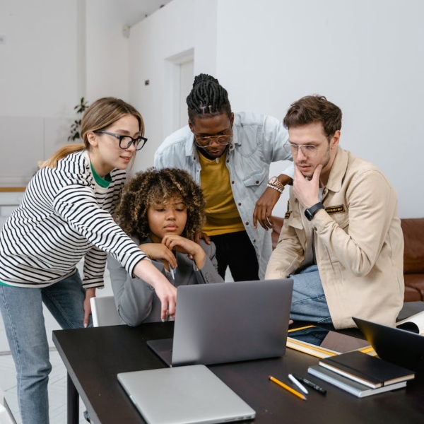 a group of people planning while looking at the laptop