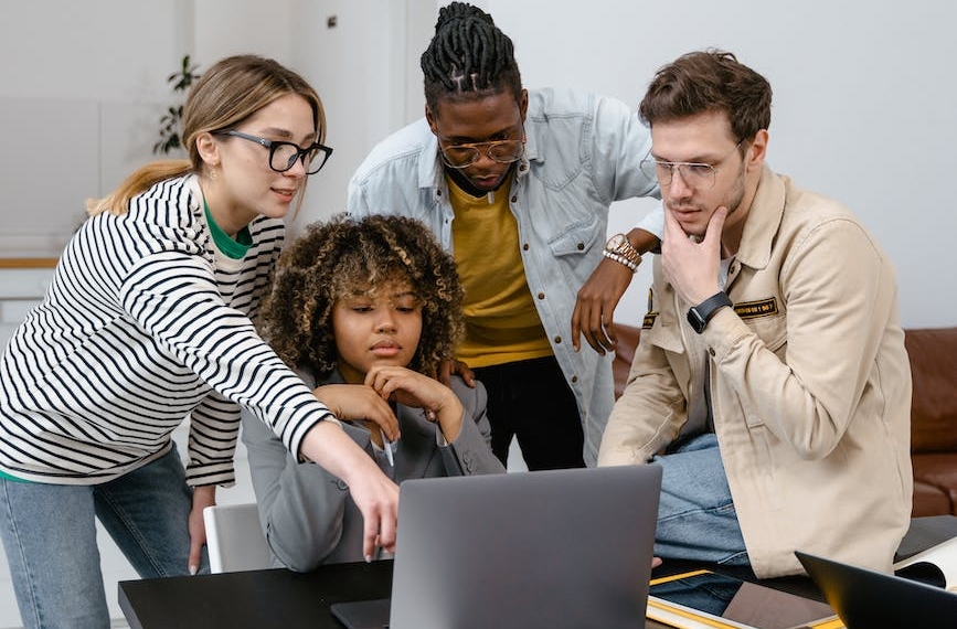 a group of people planning while looking at the laptop