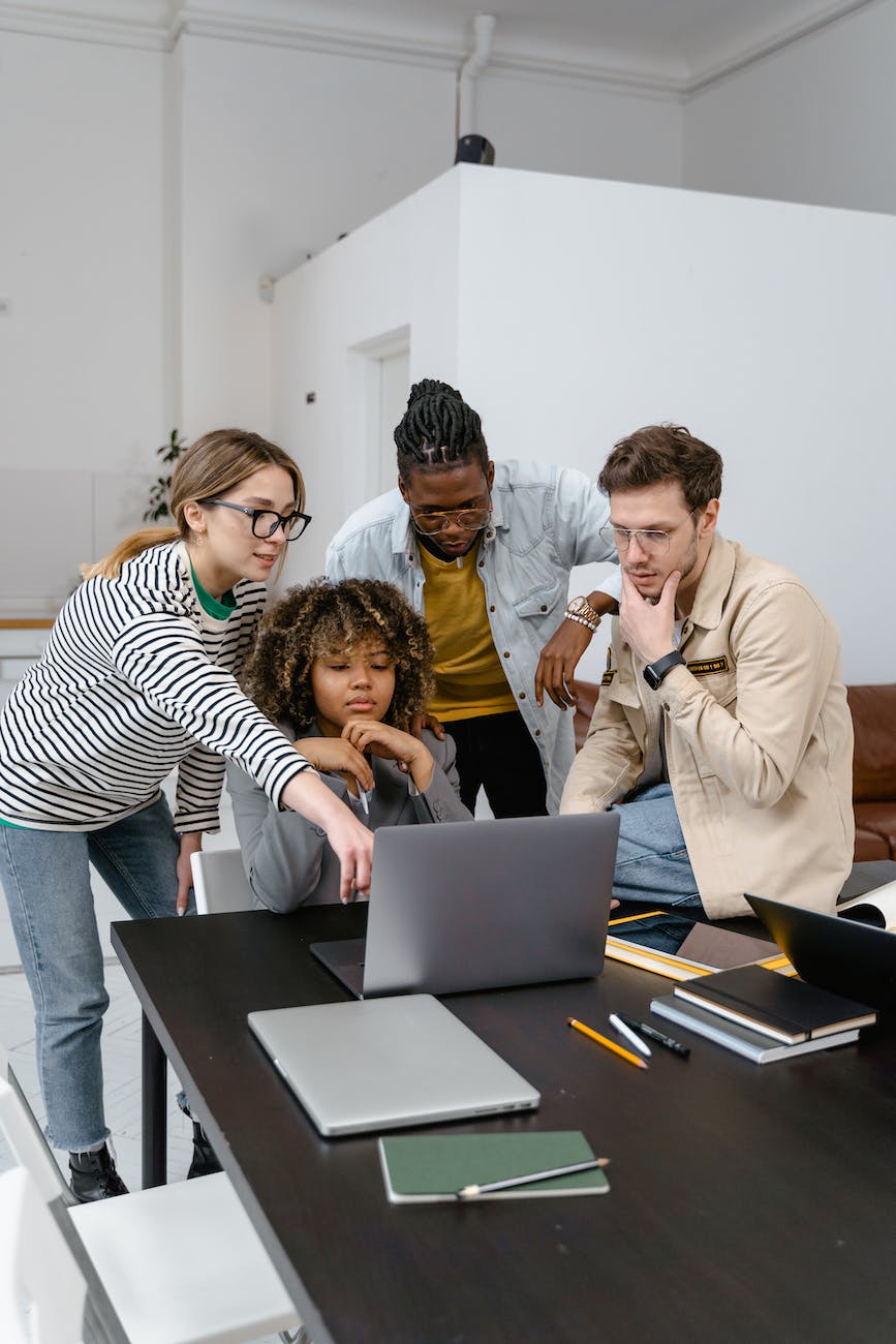 a group of people planning while looking at the laptop