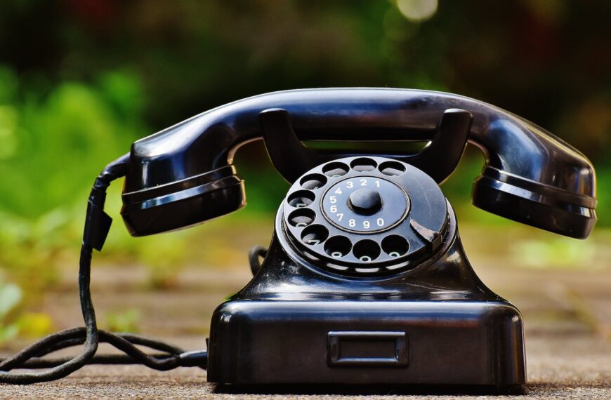 selective focus photography of black rotary phone