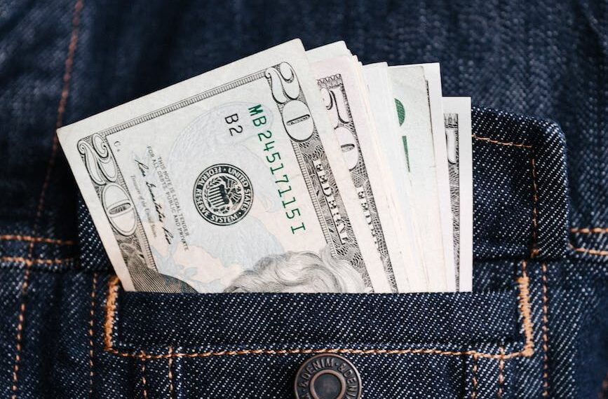 crop man with various banknotes in pocket