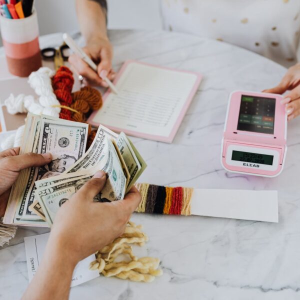 hands holding us dollar bills