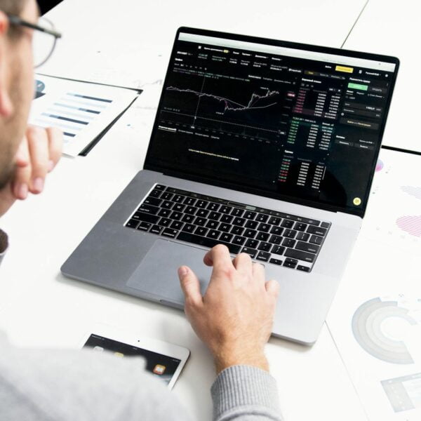 a person using a laptop with a chart on screen