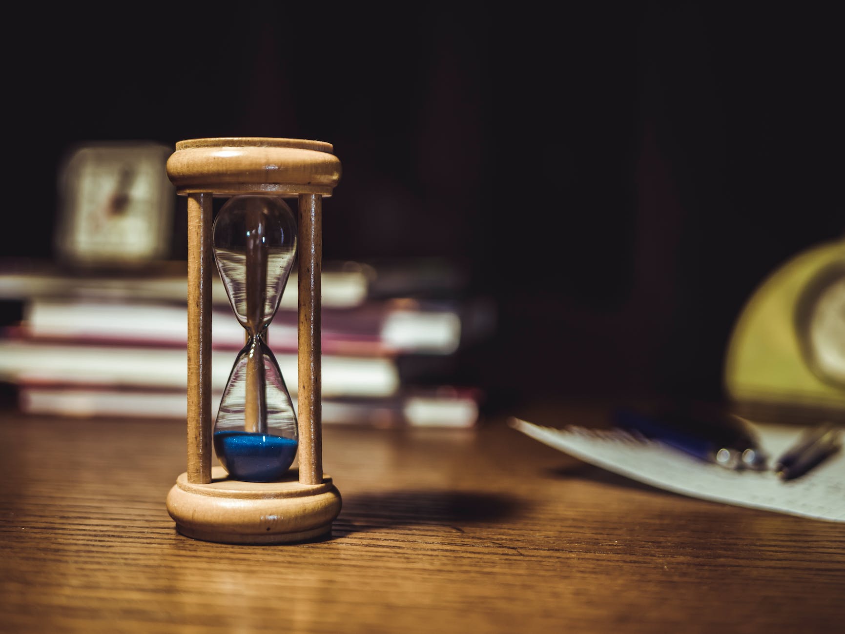 hourglass on brown wooden frame