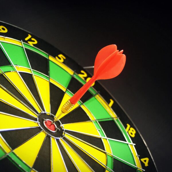 red and brass dart pin on dartboard