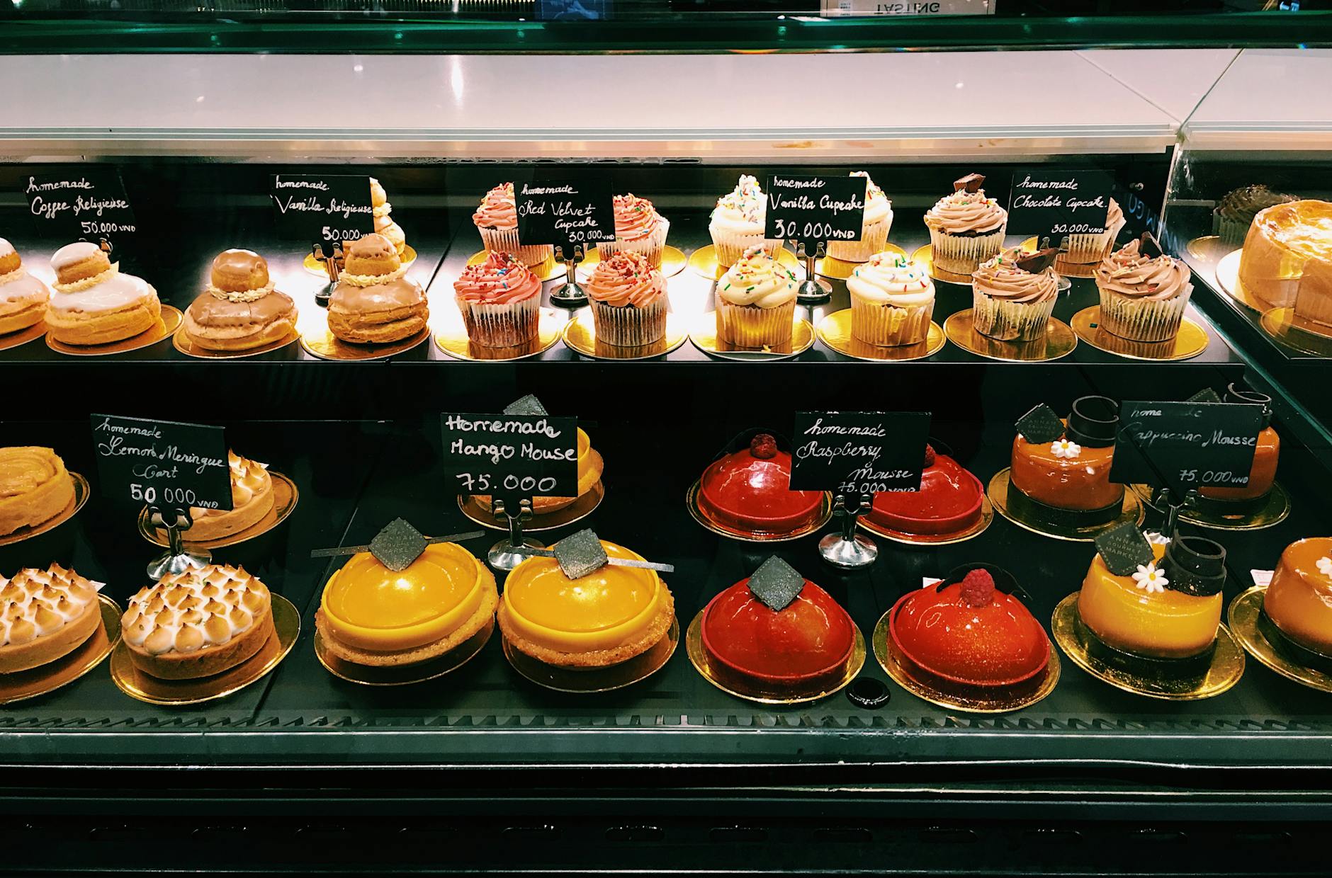 shelves of assorted cake in a bakeshop