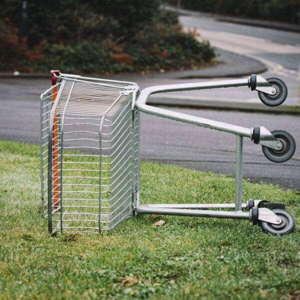 photo of abandoned shopping cart on grass