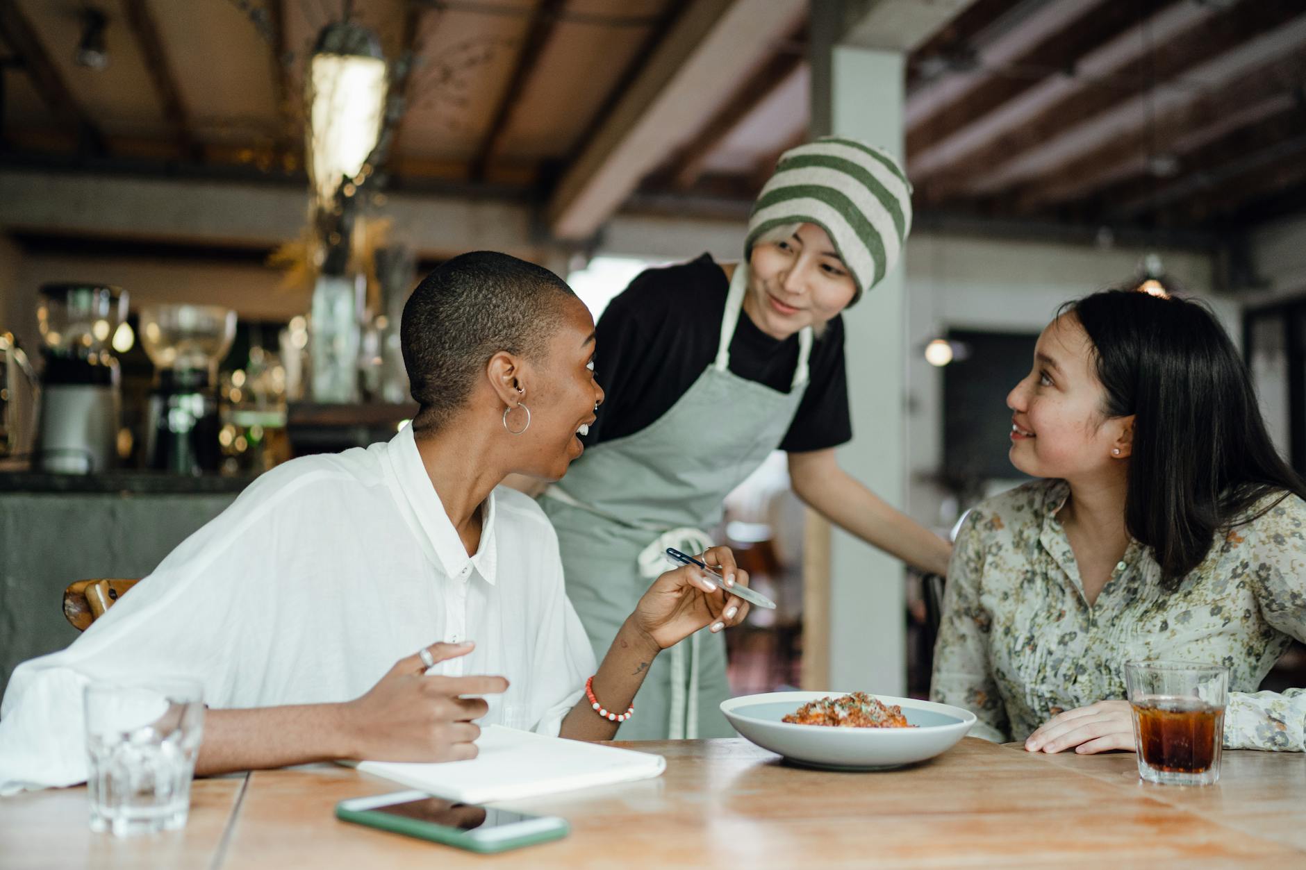 cheerful colleagues tasting food in cafeteria