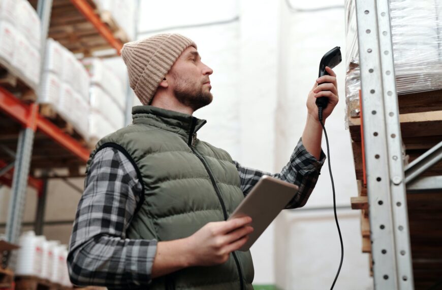 photo of a man scanning products in a warehouse