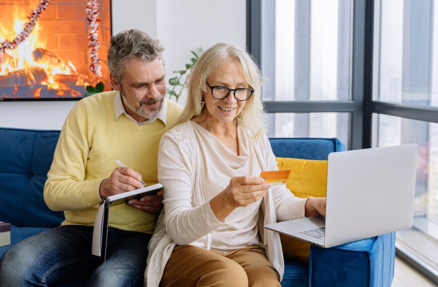 an elderly couple looking at a bank card