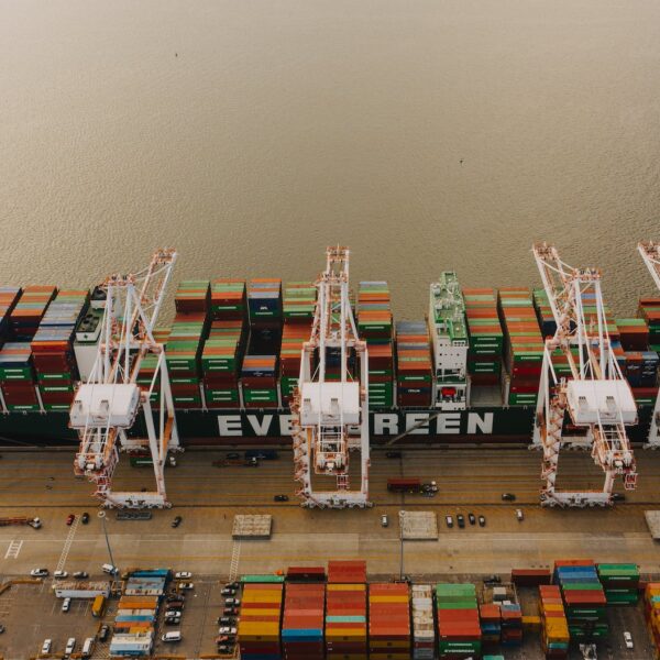 cargo ship near pier with lifting cranes