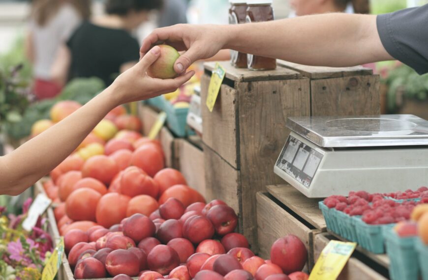 person giving fruit to another