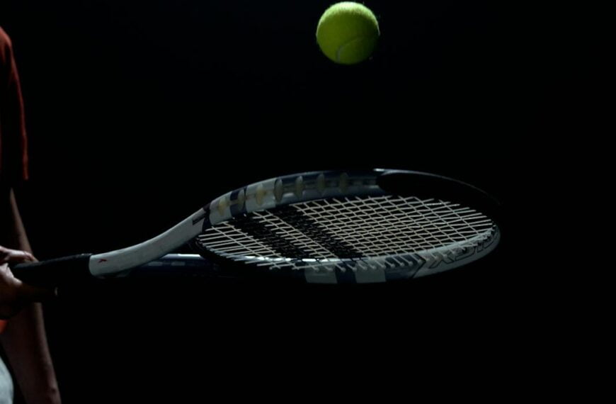 a player bouncing the tennis ball off his racket