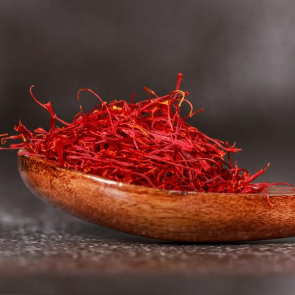 red saffron spice on brown wooden spoon