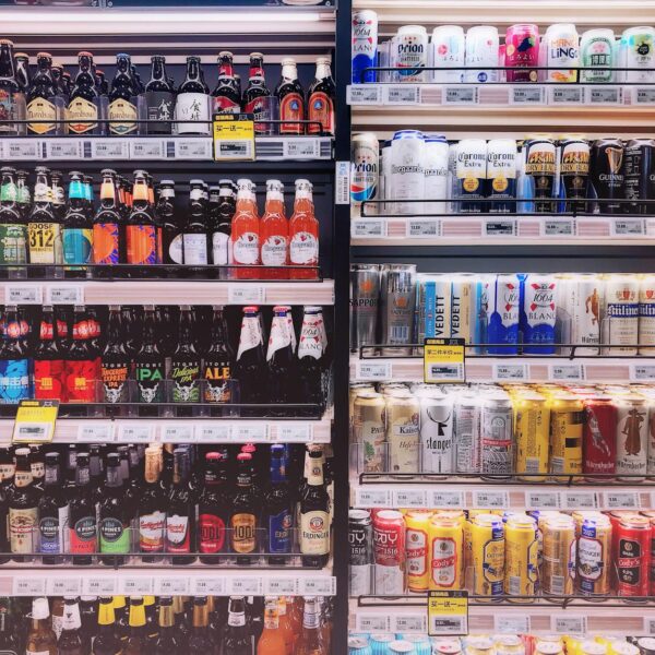 assorted bottles and cans in commercial coolers