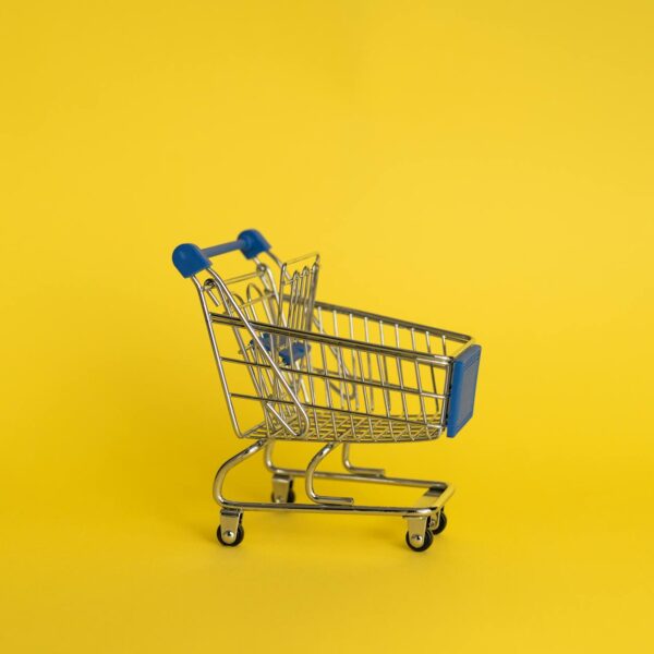 empty shopping cart on yellow background