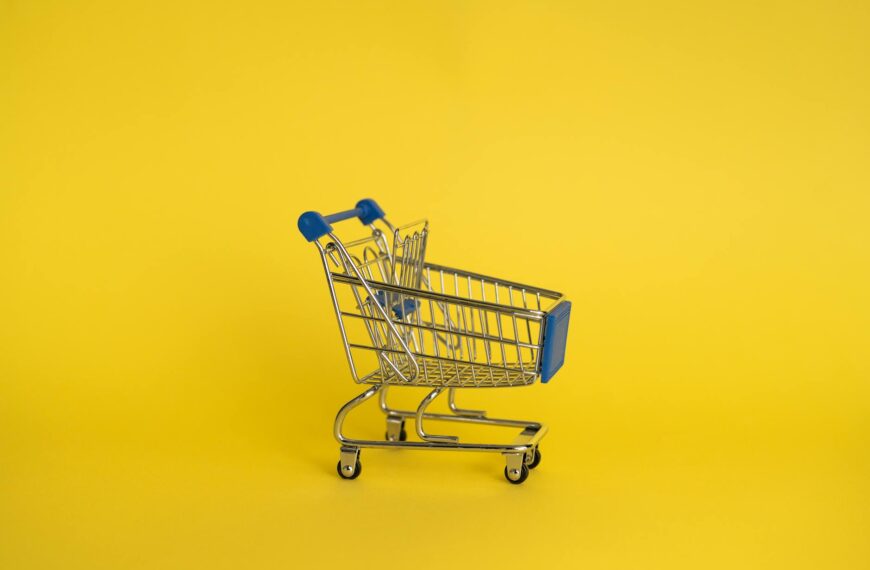 empty shopping cart on yellow background